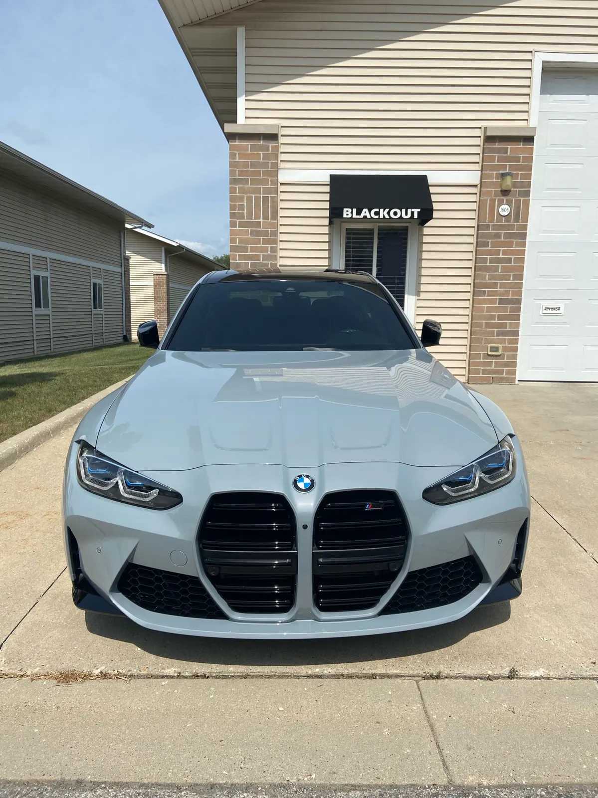 BMW M3 parked in front of the Blackout Window Service shop in Waukesha