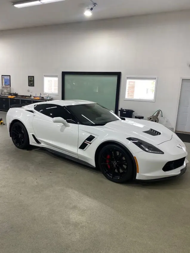 White Corvette in the shop bay