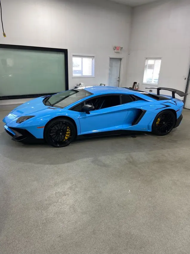 Light blue Lamborghini Aventador in the shop bay