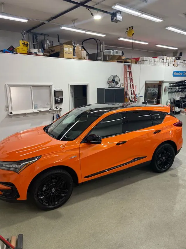 Orange Acura SUV in the shop
